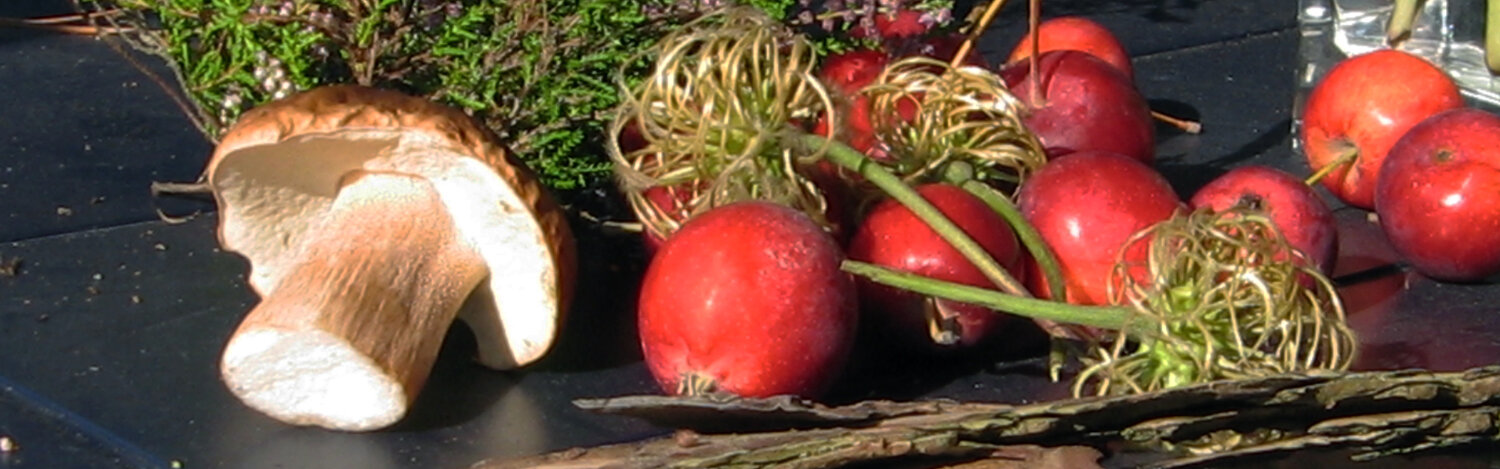 Typical autumn decoration on a table: apples, a mushroom, heather