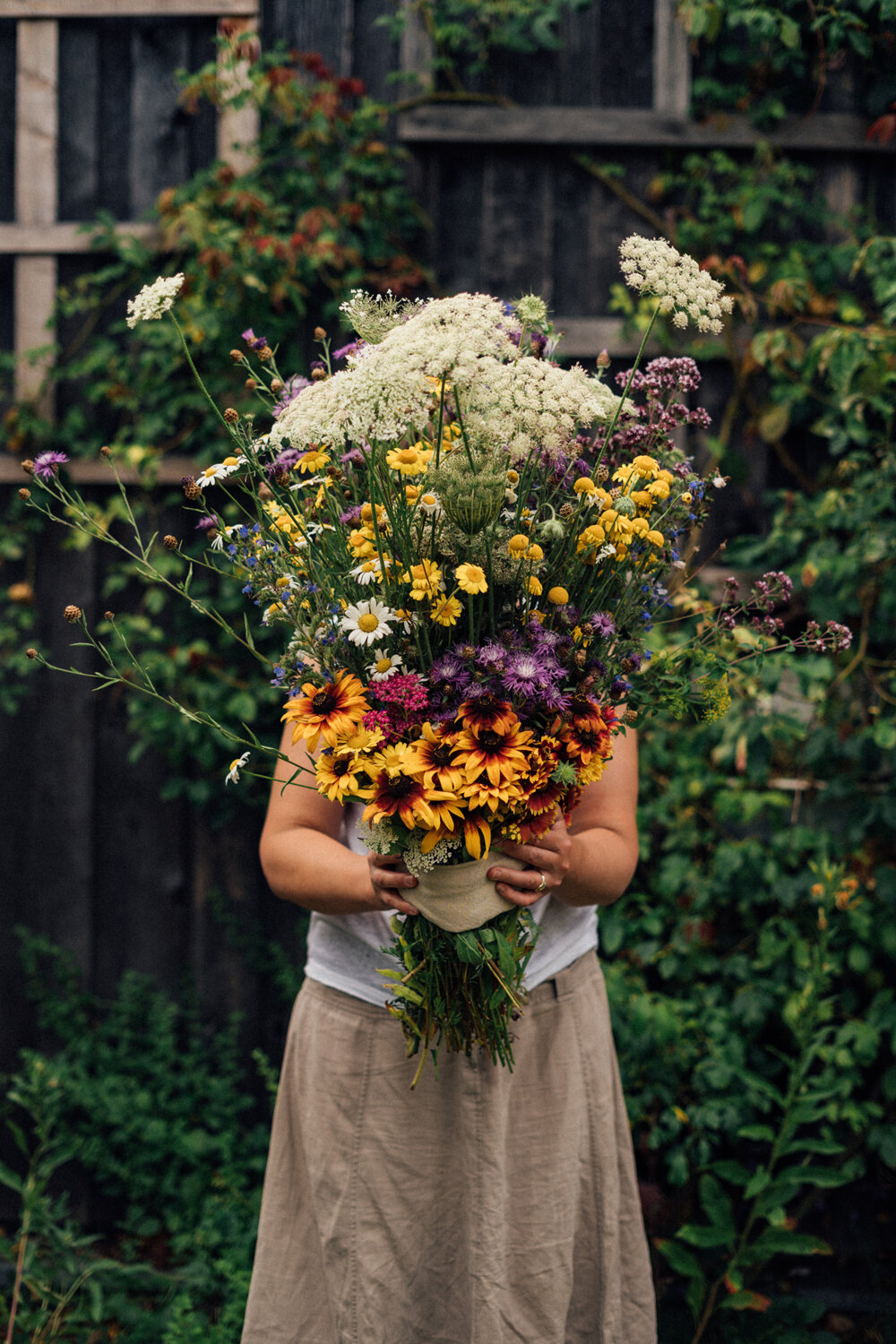 Woman with a large homemade bouquet of wildflowers