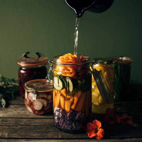 Vegetables for fermenting: carrots, courgette and red cabbage in a clip-top jar topped up with brine